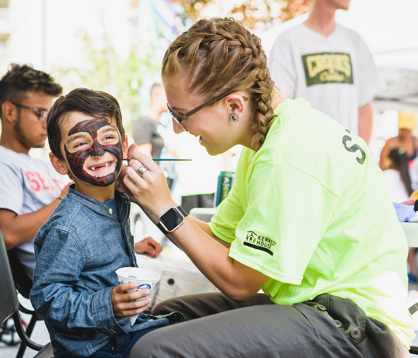 A young child getting their face painted