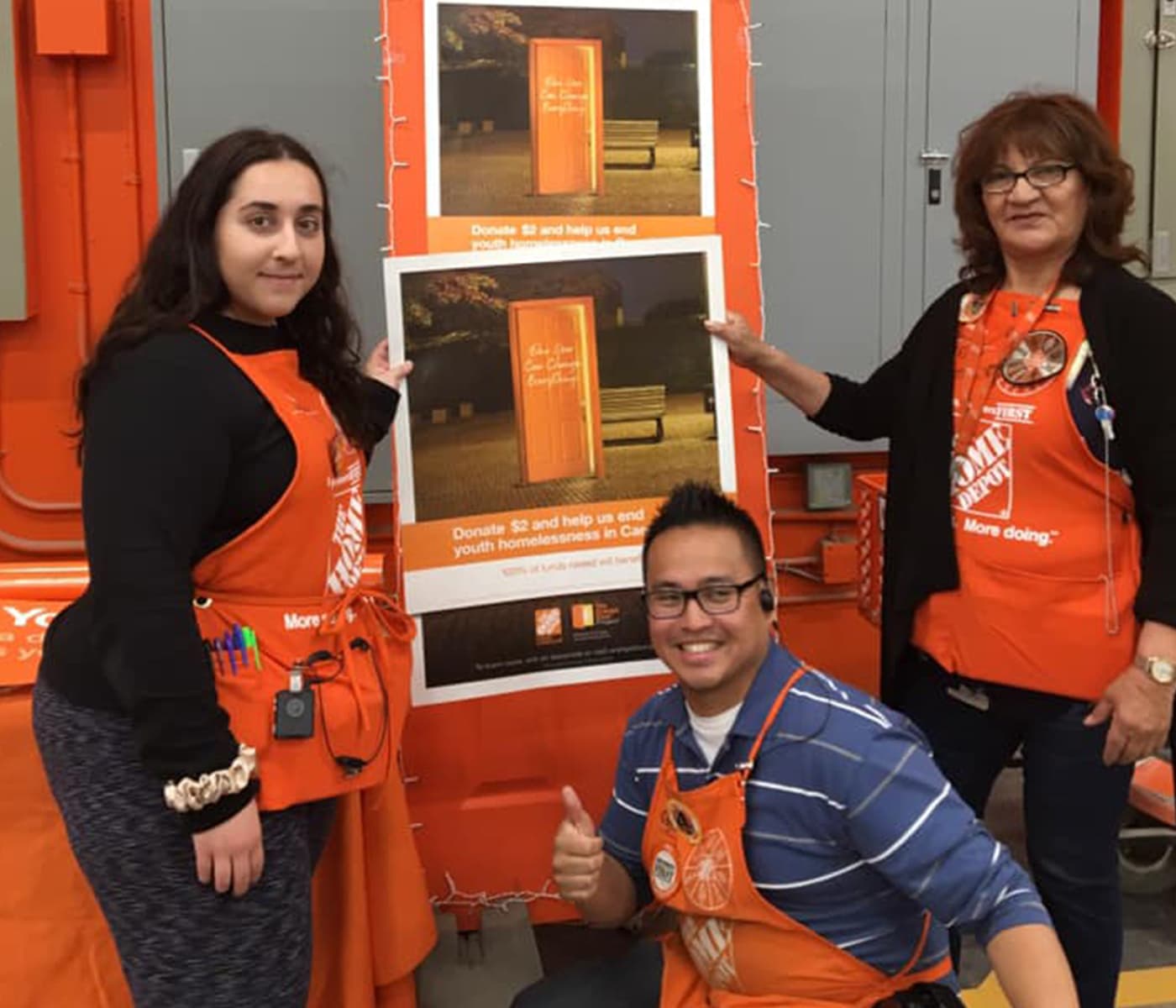 Three people form Home Depot helping out with a fundraiser